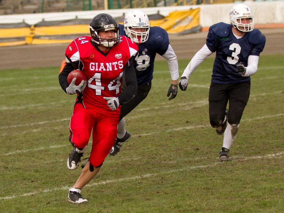 Wojtek Kosendiak carrying the ball during an American football game