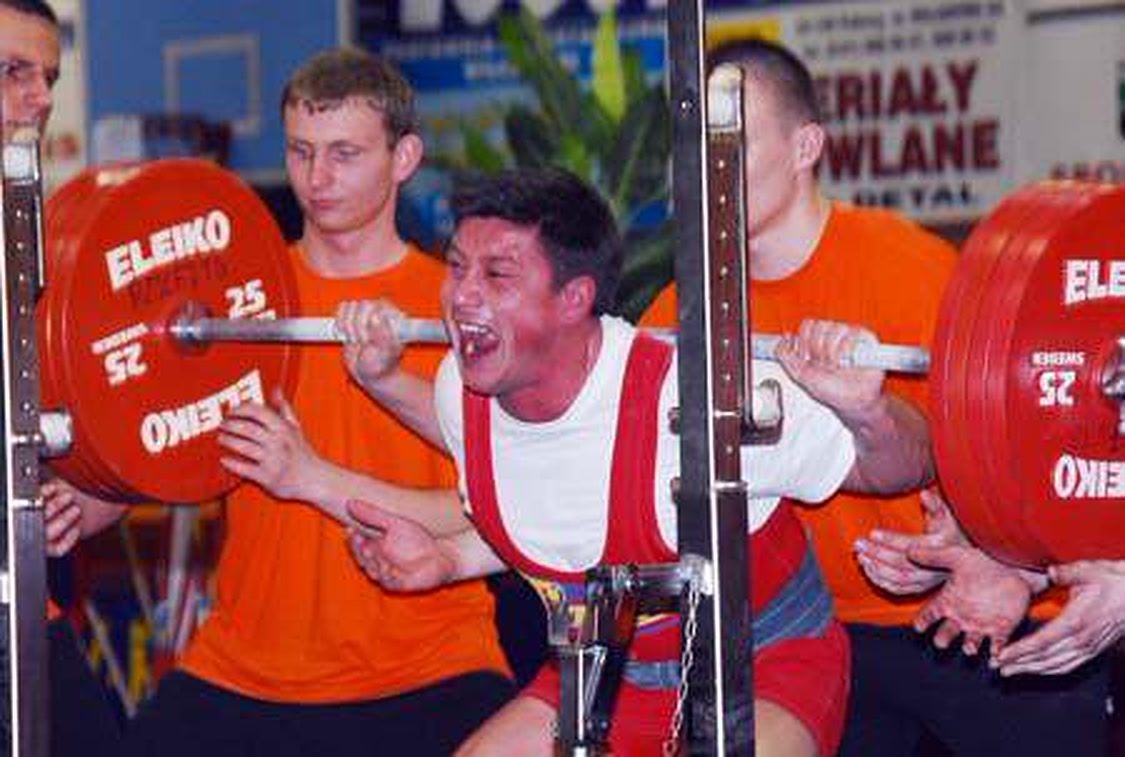 Wojtek Kosendiak competing in a powerlifting squat